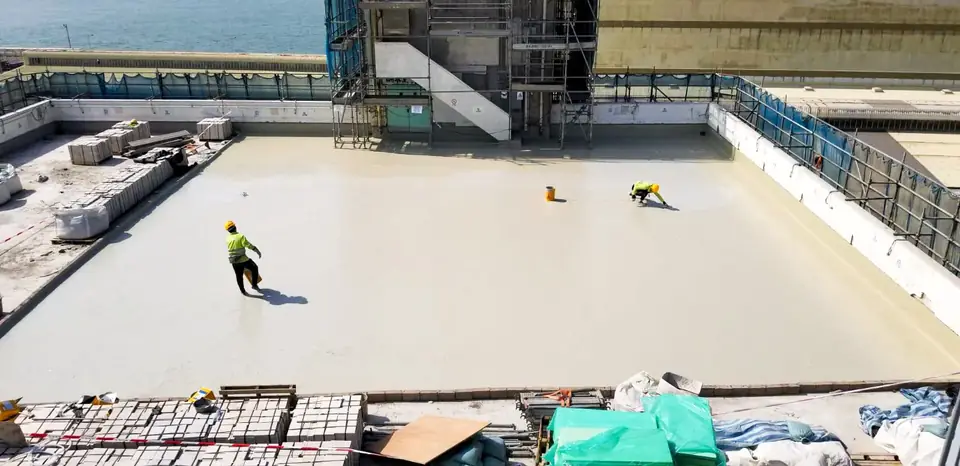 青衣蜆殼油庫兩名施工人員在設有棚架的大型淺色平屋面上工作