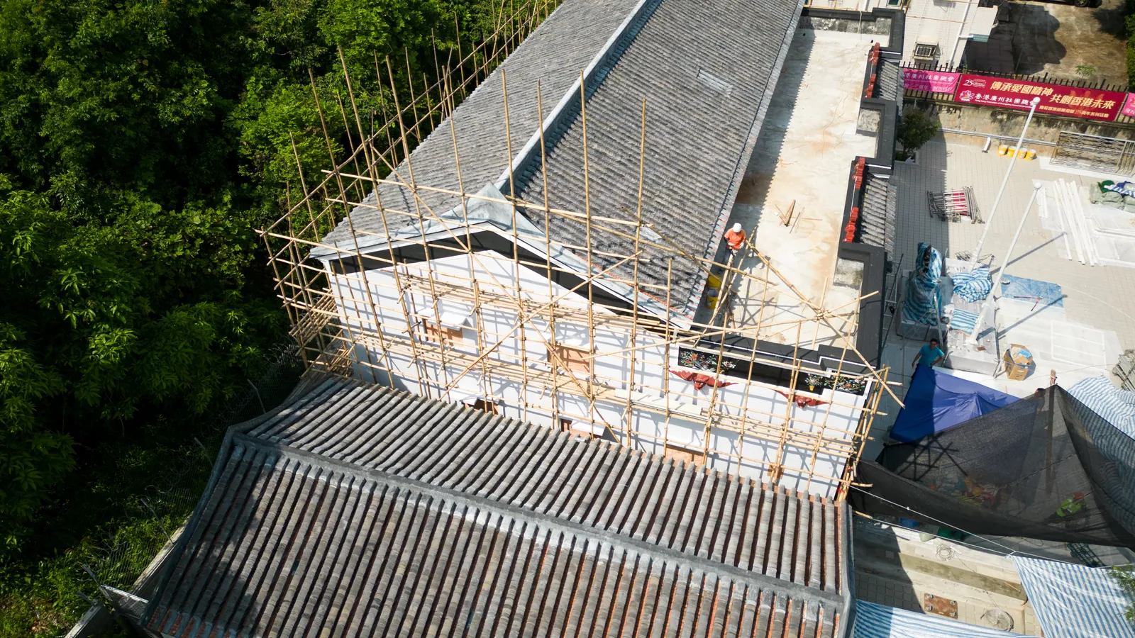 Overhead aerial view of the tiled roofs and surrounding scaffolding at Law Uk Historic House