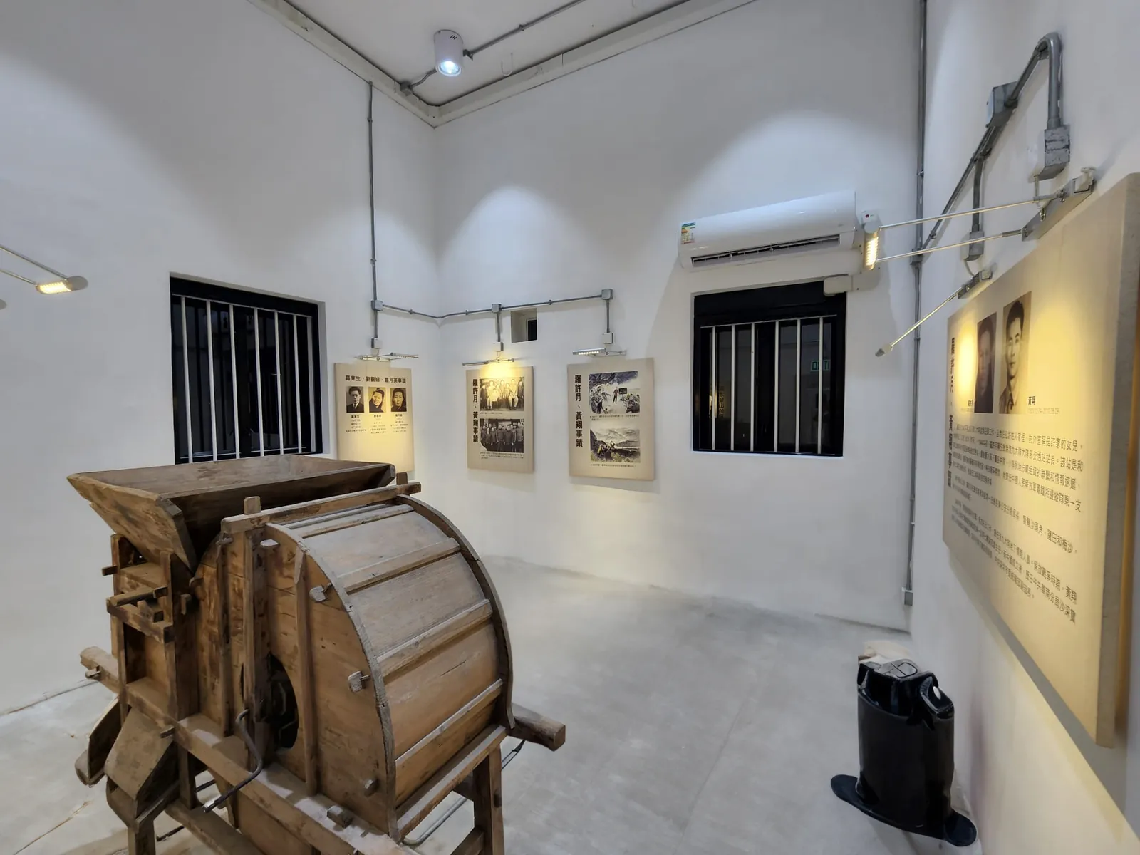 Interior exhibition room at Law Uk Historic House with a wooden agricultural implement and wall displays