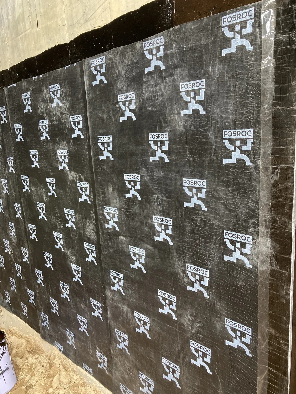 Close-up of black panels fixed to a vertical wall above soil at the Villa Panova site in Sai Kung.