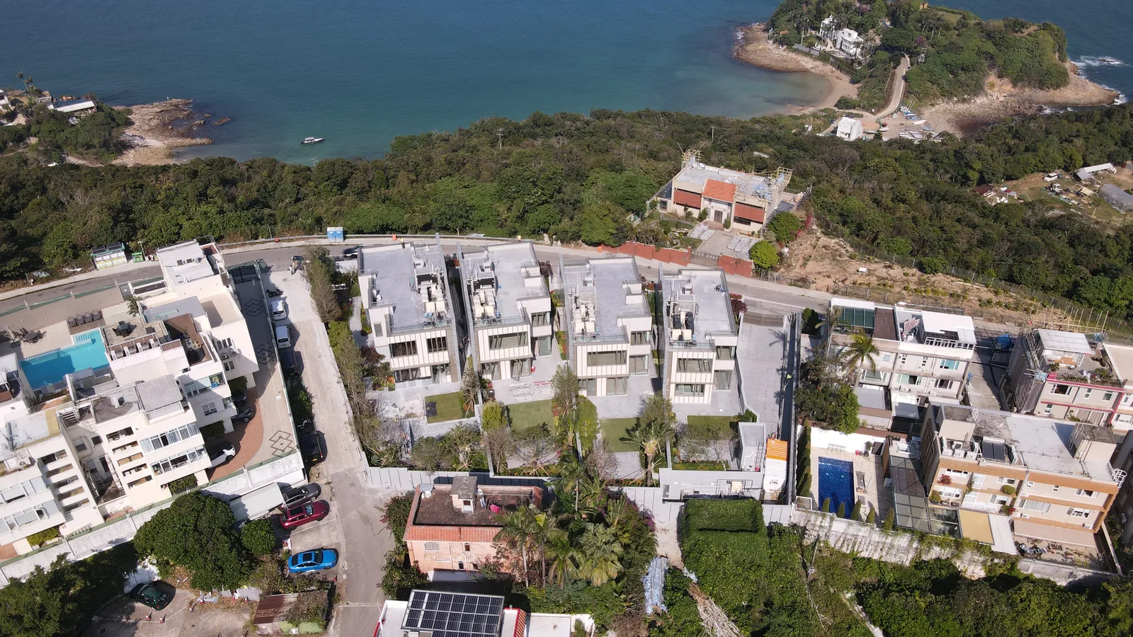 Aerial view of the low-rise Villa Panova residential development near the coast and hills in Sai Kung.
