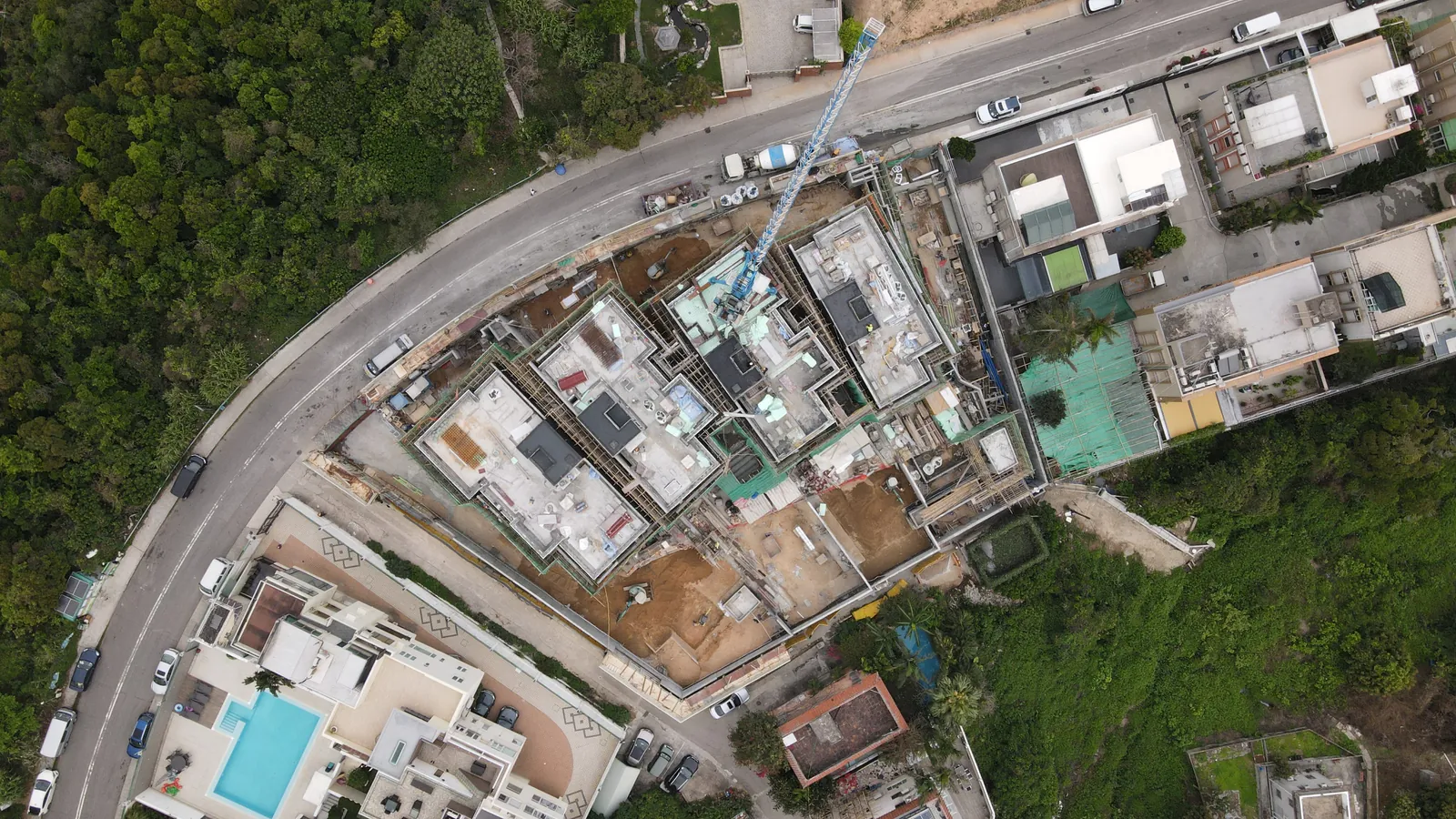 Top-down aerial view of the Villa Panova residential site beside a curved road in Sai Kung.