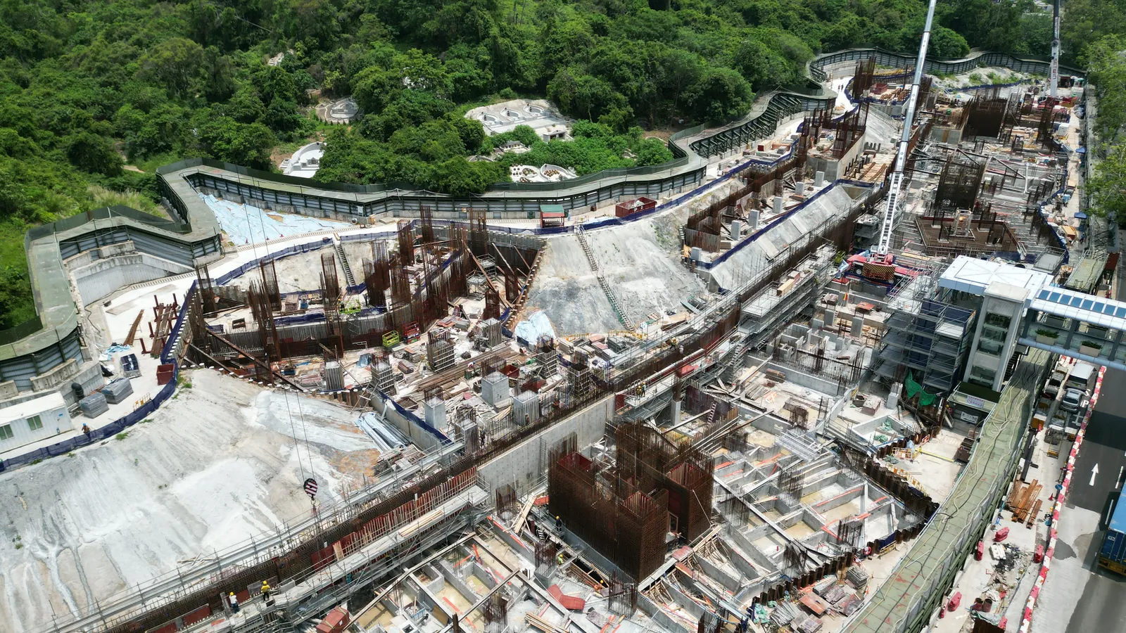 Wide aerial view of cranes, reinforcement structures and floor areas at the Wang Chau public housing site
