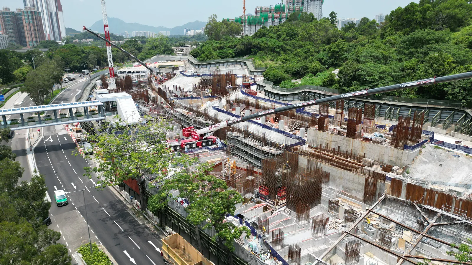 Site overview of multi-level reinforcement and formwork beside the road at the Wang Chau public housing development